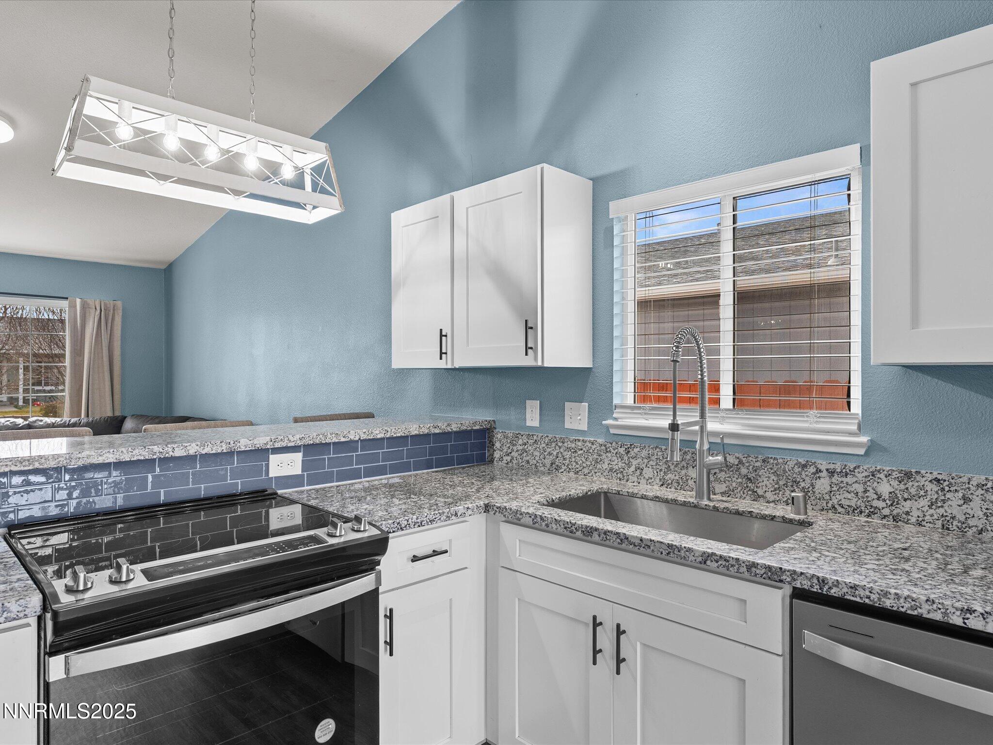 17795 Georgetown Drive Reno, NV 89508 - Photo 7 of 41 a kitchen with stainless steel appliances granite countertop a sink a stove and a granite counter tops