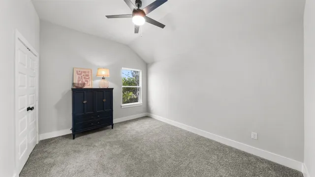 an empty room with a cabinet and mirrors