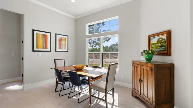 a view of a dining room with furniture and a potted plant