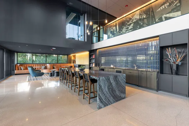 a living room with furniture a rug and a projector