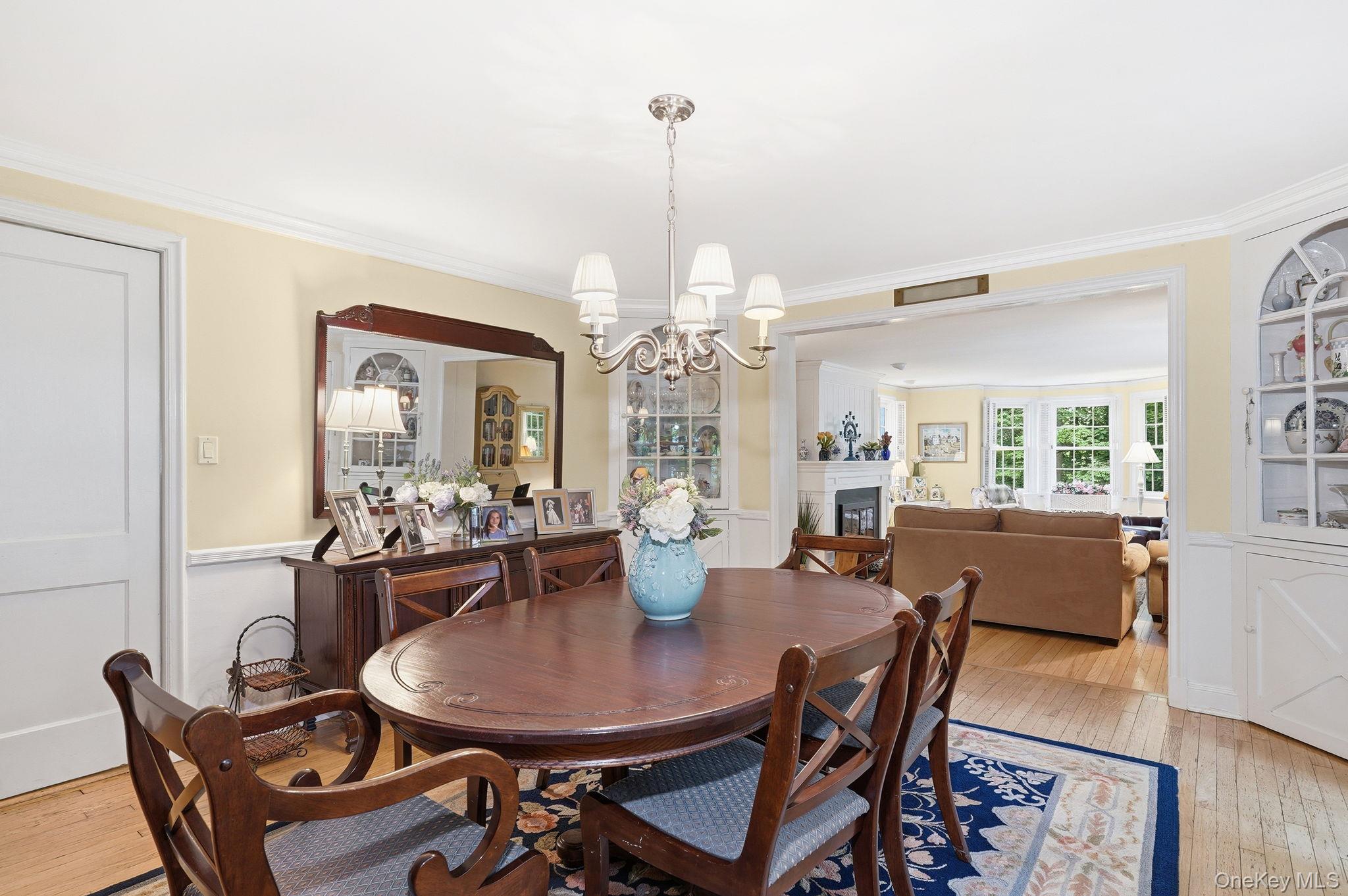 26 Cedarlawn Road Irvington, NY 10533 - Photo 9 of 34 a dining room with furniture a chandelier and wooden floor