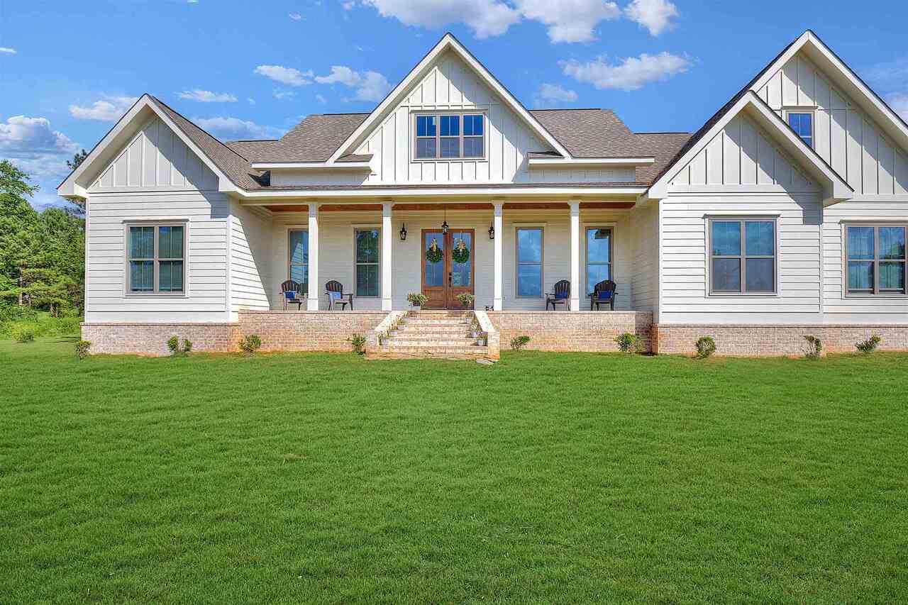 a front view of a house with a yard and porch
