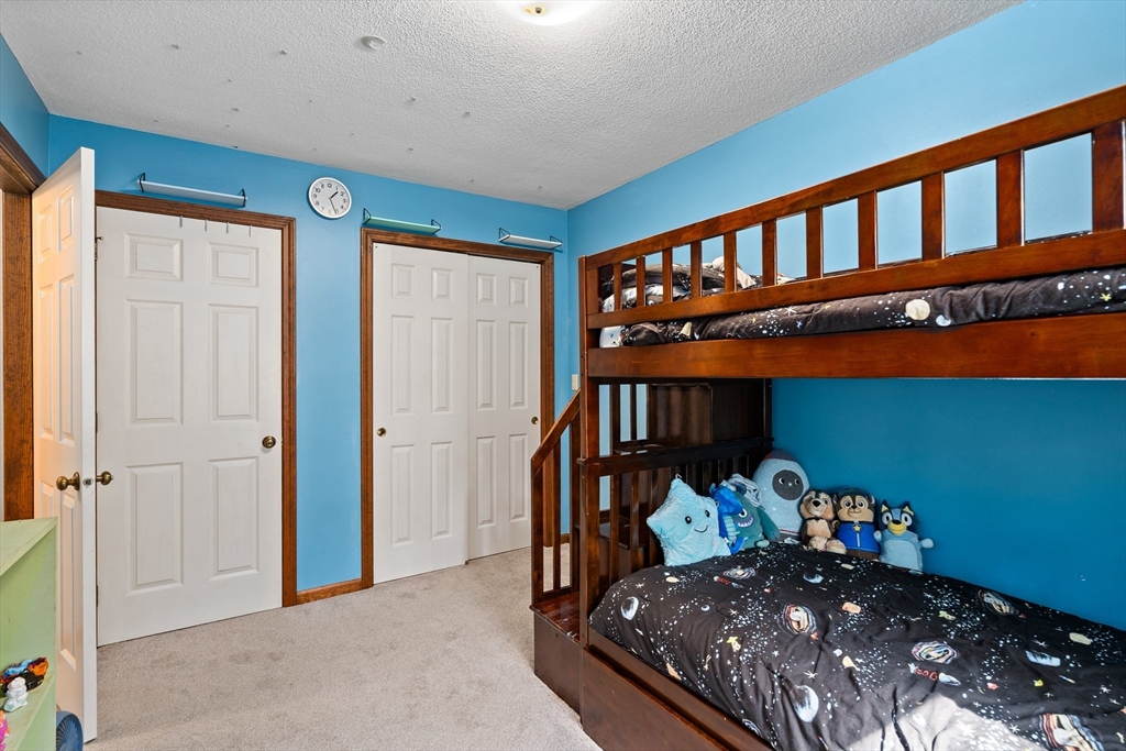 634 Burts Pit Road Northampton, MA 01062 - Photo 33 of 42 a bedroom with a bed and a large window