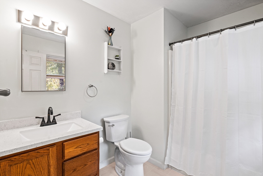 634 Burts Pit Road Northampton, MA 01062 - Photo 36 of 42 a bathroom with a granite countertop sink and a toilet