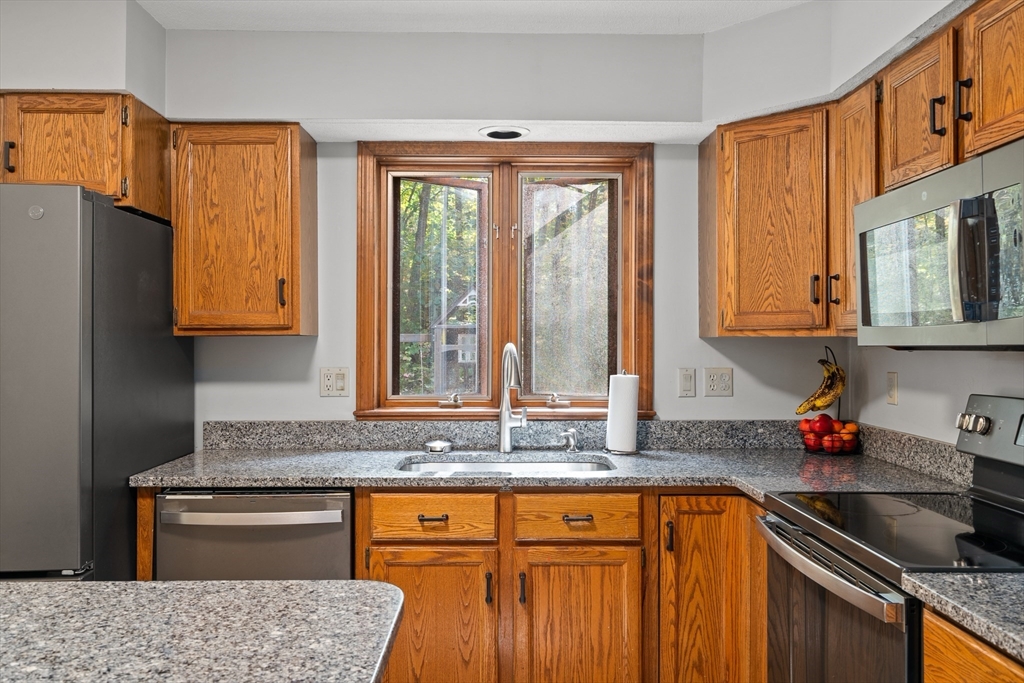 634 Burts Pit Road Northampton, MA 01062 - Photo 8 of 42 a kitchen with stainless steel appliances granite countertop a sink stove and cabinets