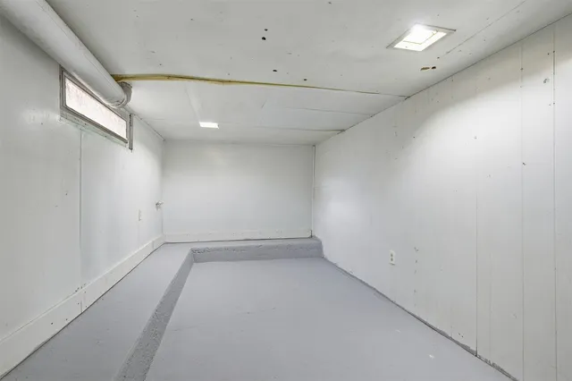 an empty room with a empty space and windows