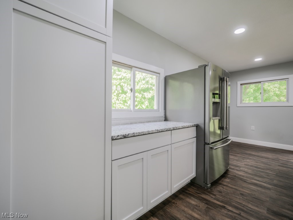39330 Chestnut Ridge Road Elyria, OH 44035 - Photo 12 of 32 Kitchen with dark hardwood flooring, light countertops, and stainless steel fridge with ice dispenser