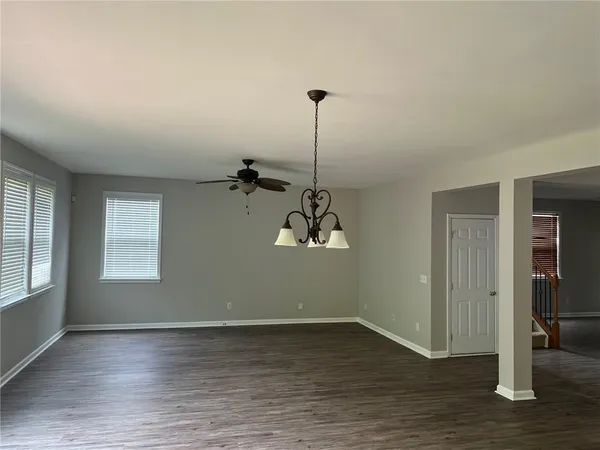 a view of a room with wooden floor and window