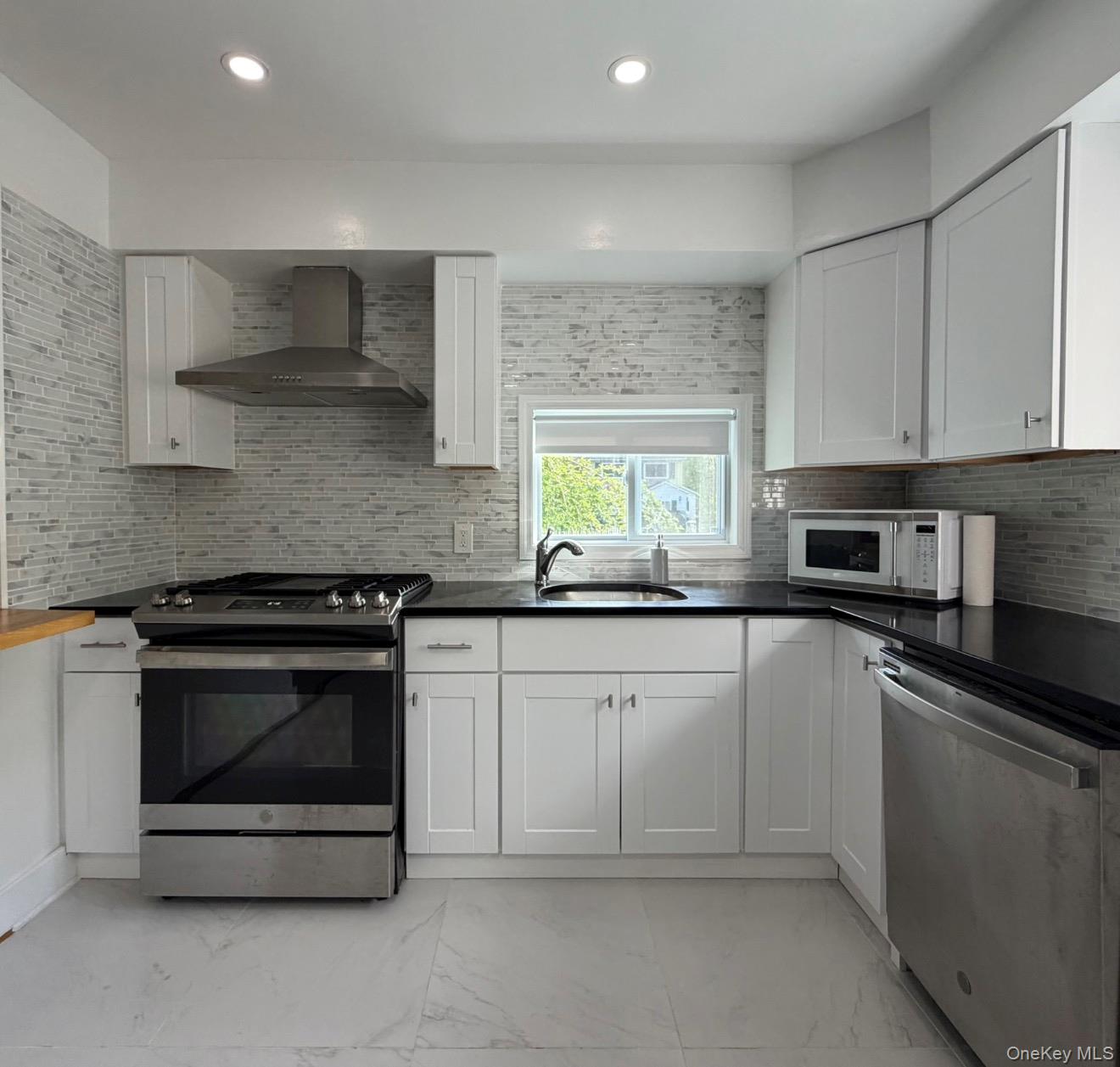 60 Medallion Road Kiamesha Lake, NY 12751 - Photo 19 of 44 a kitchen with granite countertop white cabinets and stainless steel appliances