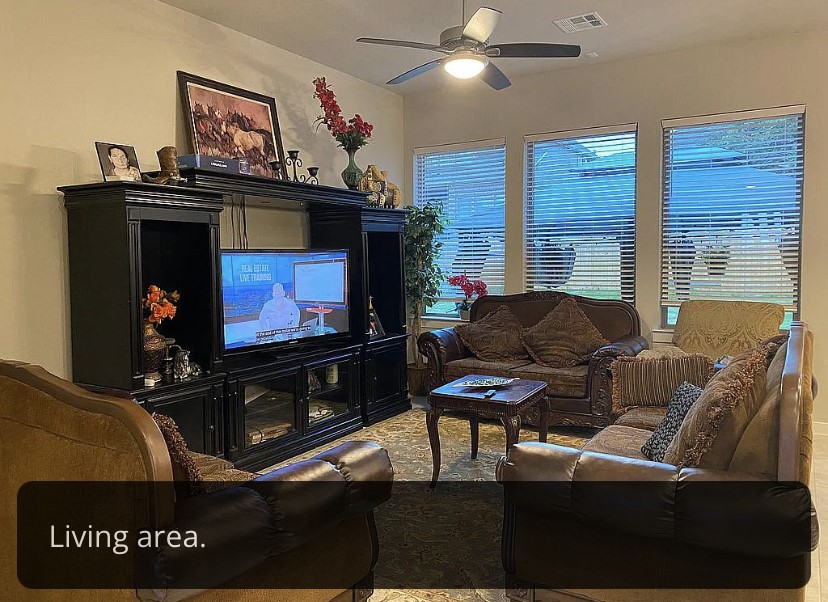 2017 Palmera Ridge Boulevard Leander, TX 78641 - Photo 11 of 17 a living room with furniture a flat screen tv and a fireplace