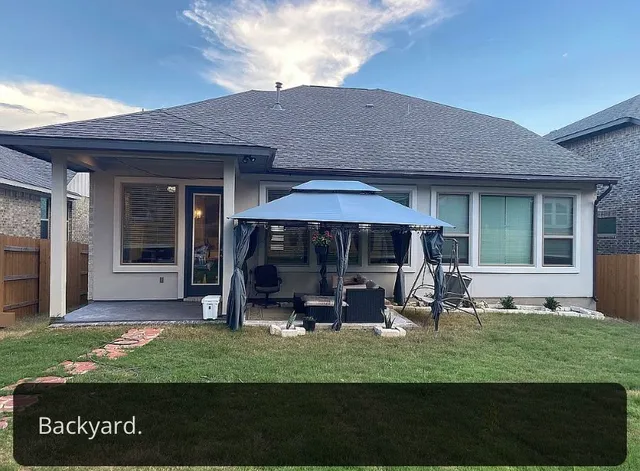 a kitchen with stainless steel appliances kitchen island granite countertop a stove a sink a refrigerator a dining table and chairs with wooden floor