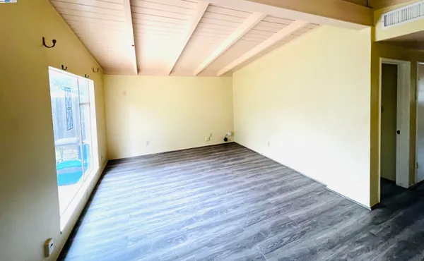 a view of a room with wooden floor