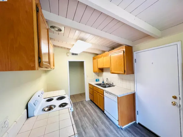 a kitchen with a sink and wooden cabinets