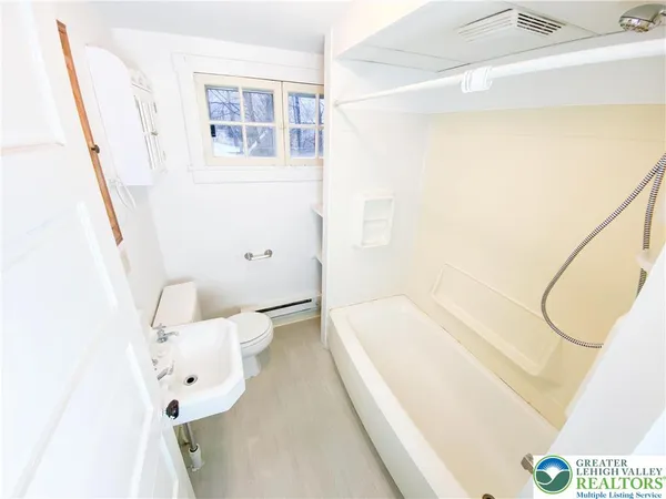 a bathroom with a bathtub sink and toilet