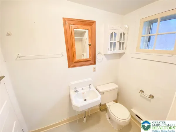 a white toilet sitting next to a bathroom sink
