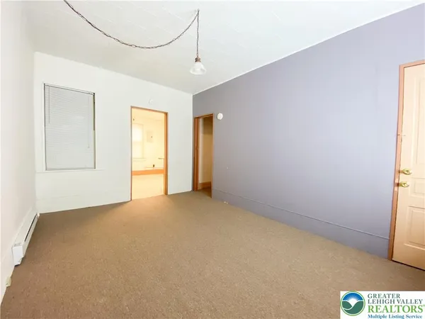 a view of an empty room with a window