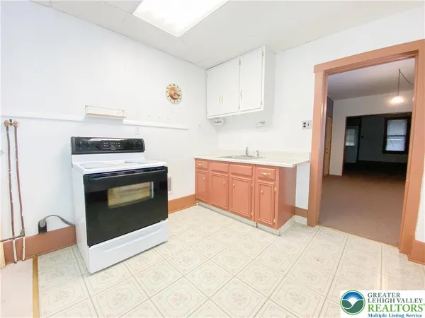 a kitchen with a stove and a sink