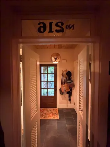 a dining room with furniture a chandelier and window