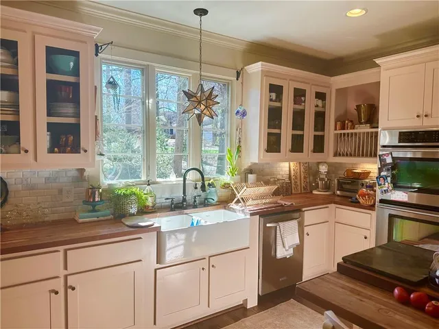 a bedroom with a bed a couches and a chandelier