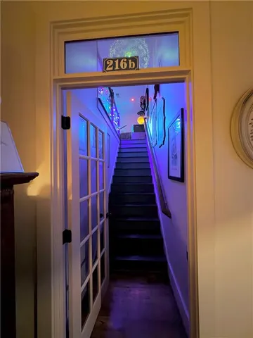 a view of a swimming pool and lounge chairs in back yard of the house