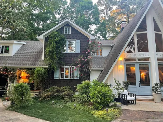 a view of a patio with table and chairs with wooden fence