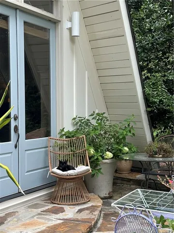 a view of a hallway with wooden floor and stairs