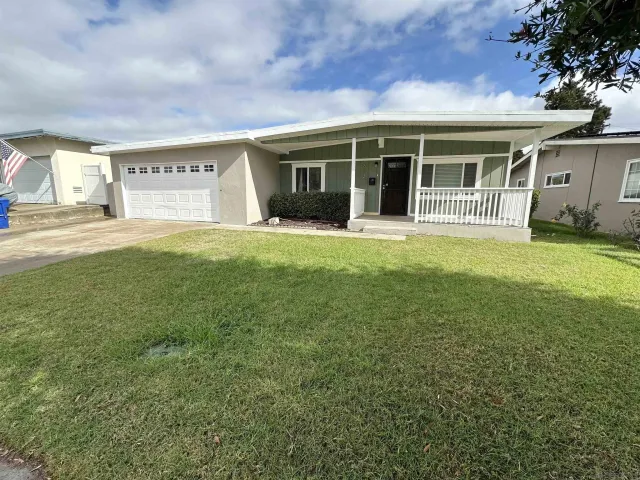 a view of a house with a garden and yard