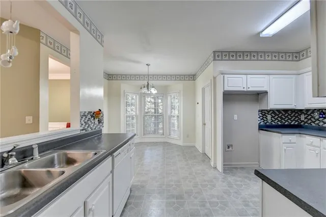 a kitchen with granite countertop a sink and a refrigerator