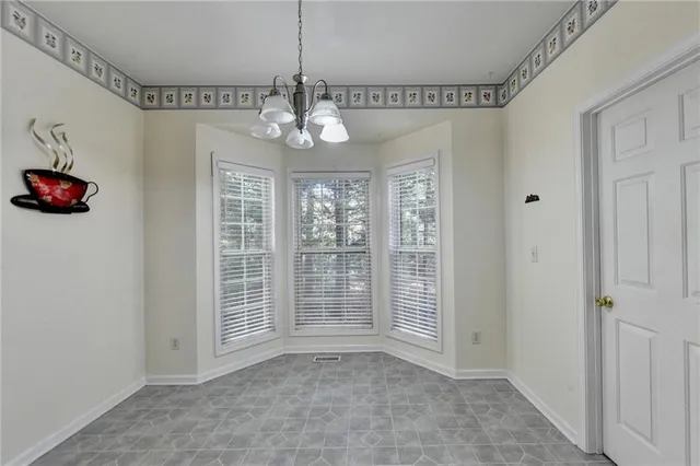 a view of a livingroom with a chandelier entryway