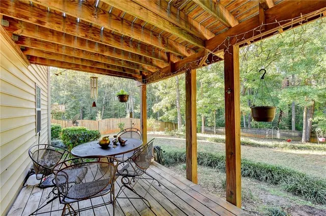 a view of a patio with table and chairs and wooden floor