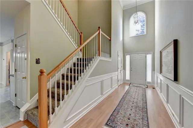 a view of a hallway with wooden floor and entryway