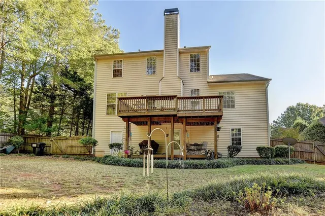 a backyard of a house with fountain and large trees
