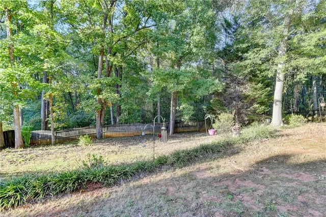 a view of balcony with wooden floor and fence