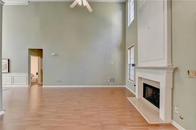 a view of a livingroom with wooden floor and a fireplace