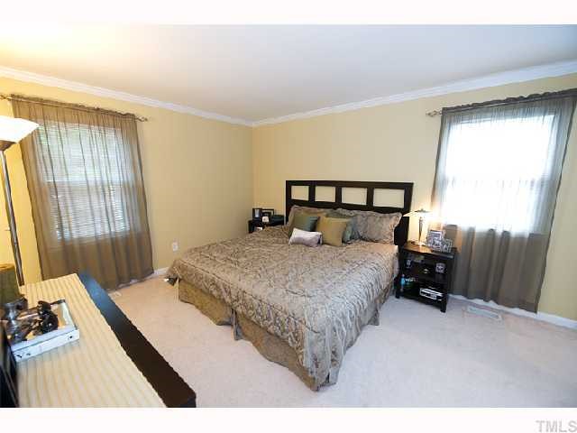 7500 Mine Shaft Road Raleigh, NC 27615 - Photo 5 of 12 a bedroom with a bed and a flat tv screen on the dresser
