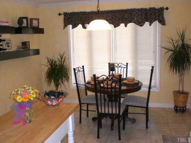7500 Mine Shaft Road Raleigh, NC 27615 - Photo 8 of 12 a view of a dining room with furniture and a potted plant