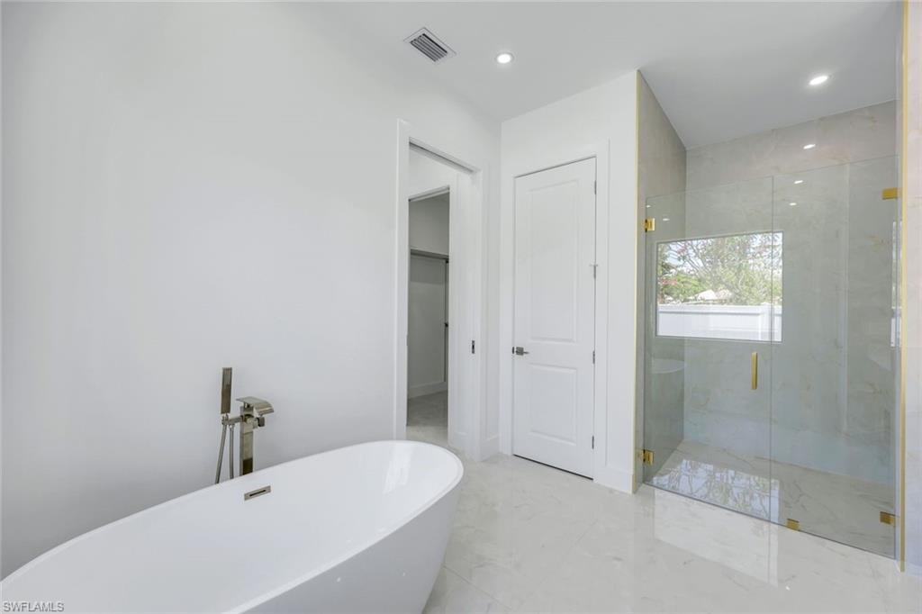 1312 Trail Terrace Drive Naples, FL 34103 - Photo 13 of 33 a bathroom with a bathtub and shower