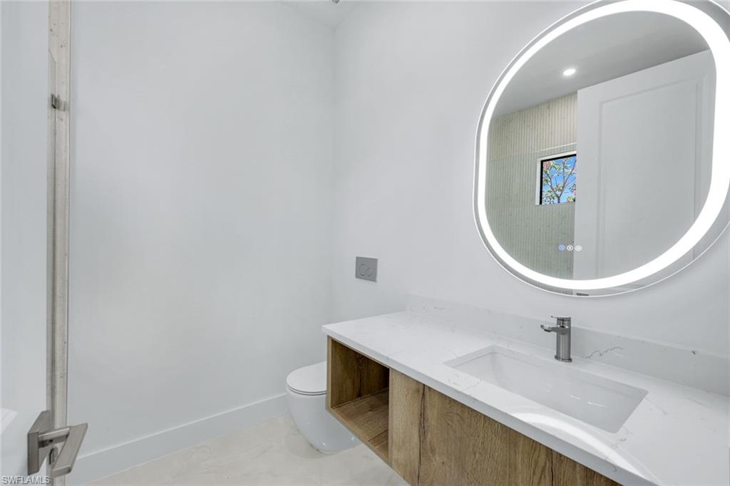 1312 Trail Terrace Drive Naples, FL 34103 - Photo 16 of 33 a bathroom with a sink and a mirror