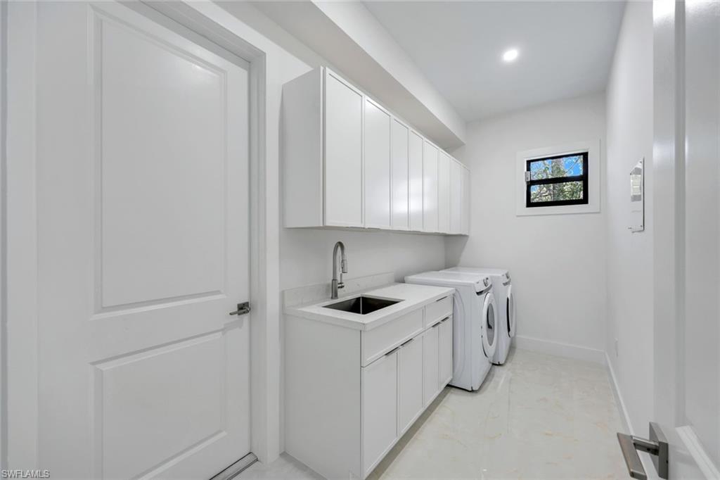 1312 Trail Terrace Drive Naples, FL 34103 - Photo 20 of 33 a view of a kitchen with white cabinets and white appliances