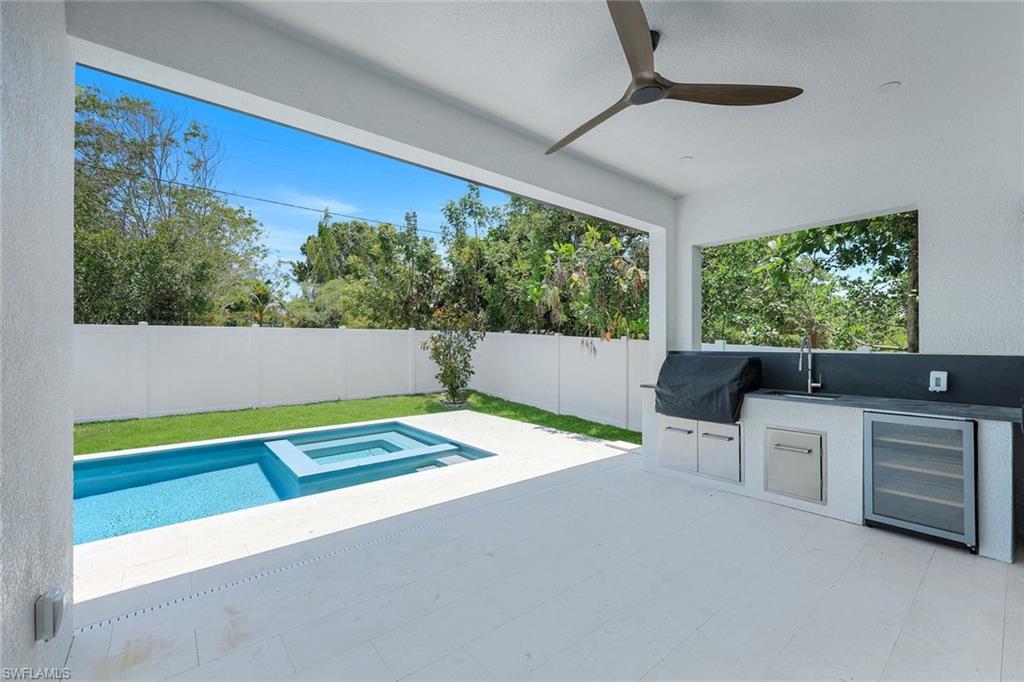 1312 Trail Terrace Drive Naples, FL 34103 - Photo 21 of 33 a living room with furniture and a large window