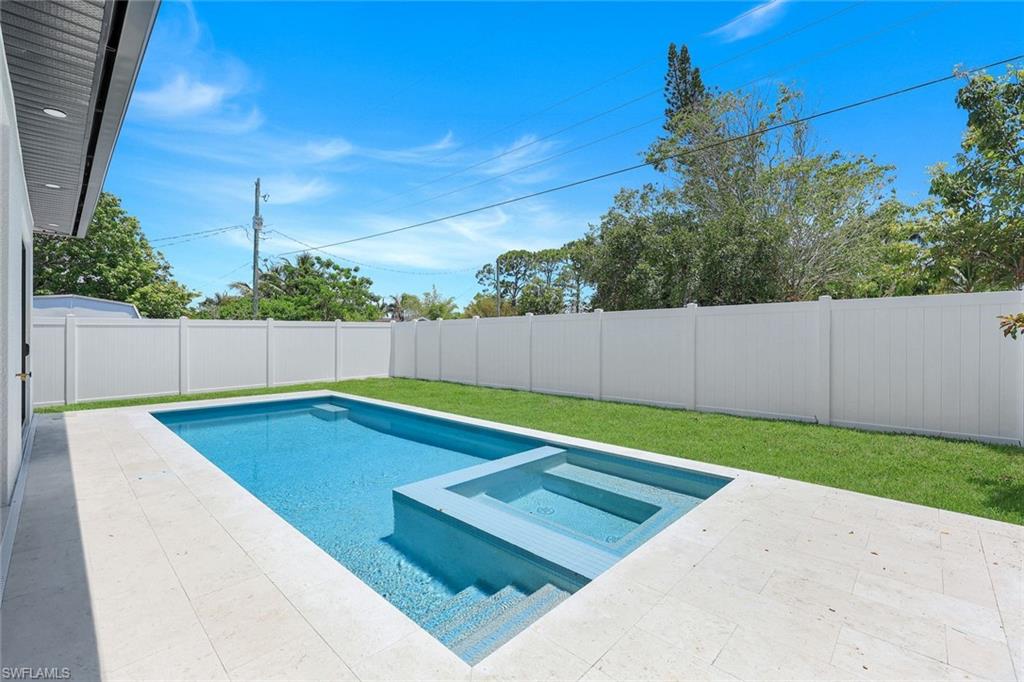 1312 Trail Terrace Drive Naples, FL 34103 - Photo 23 of 33 a view of a swimming pool with a yard