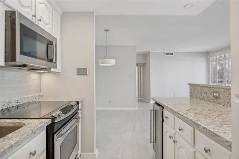 a kitchen with granite countertop a stove and a sink