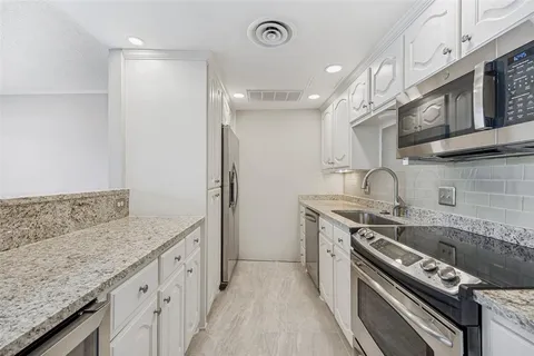 a kitchen with a stove and a sink