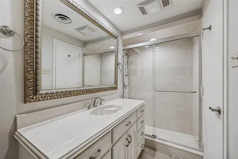 a bathroom with a sink mirror vanity and toilet