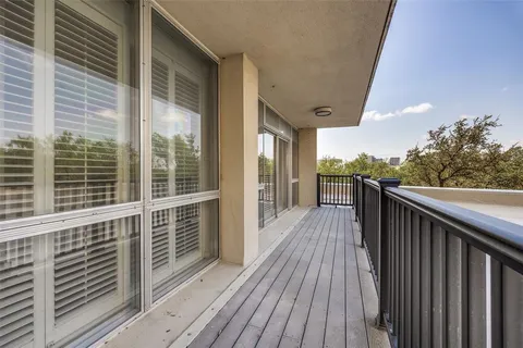 a view of balcony with wooden floor and fence