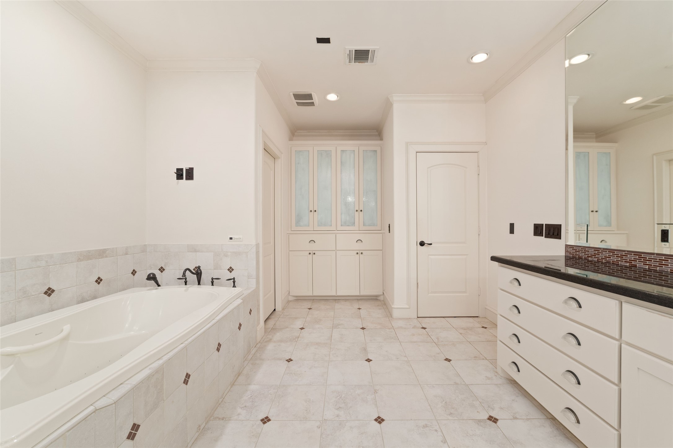 4102 Gramercy Street Houston, TX 77025 - Photo 24 of 35 a spacious bathroom with a granite countertop sink a mirror and a bathtub
