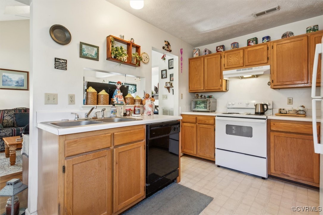 147 Rain Tree Way Williamsburg, VA 23188 - Photo 15 of 36 a kitchen with a white cabinets and white appliances