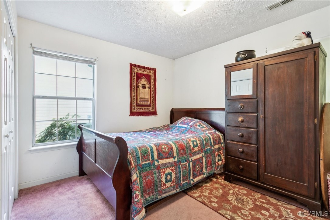 147 Rain Tree Way Williamsburg, VA 23188 - Photo 19 of 36 a bedroom with a bed and a window