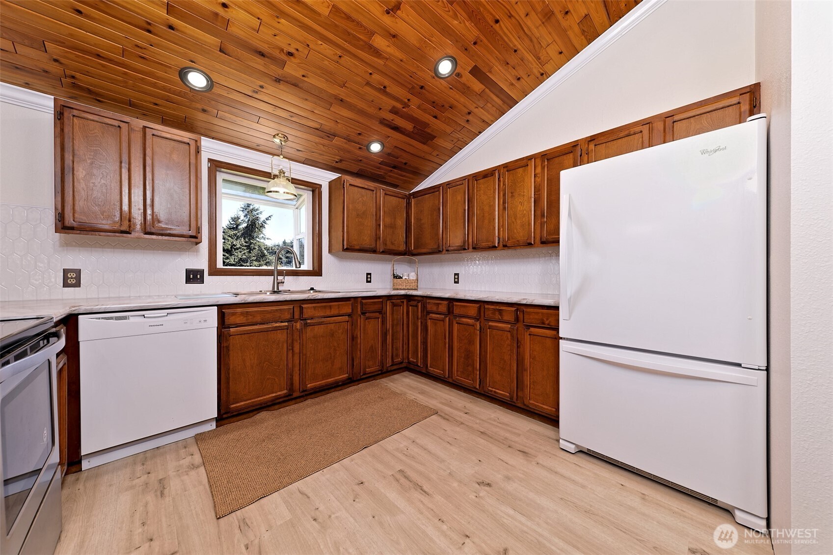 247-24 Woodard Road Chehalis, WA 98532 - Photo 10 of 40 a kitchen with granite countertop wooden cabinets a sink a window and stainless steel appliances