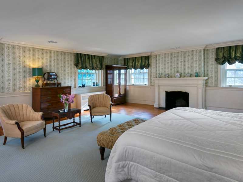 440 Middlesex Road Darien, CT 06820 - Photo 14 of 24 a bedroom with furniture and a fireplace